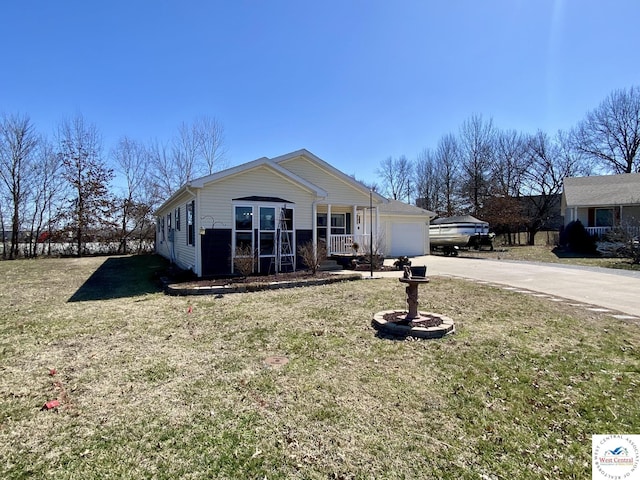 view of front facade with driveway, covered porch, a garage, and a front lawn