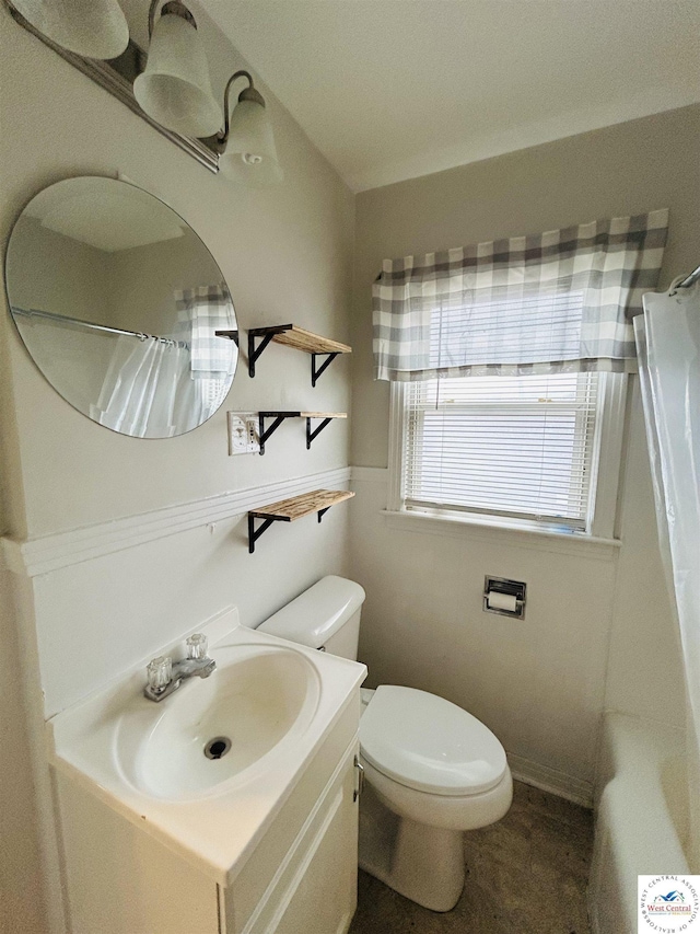 bathroom featuring curtained shower, vanity, and toilet