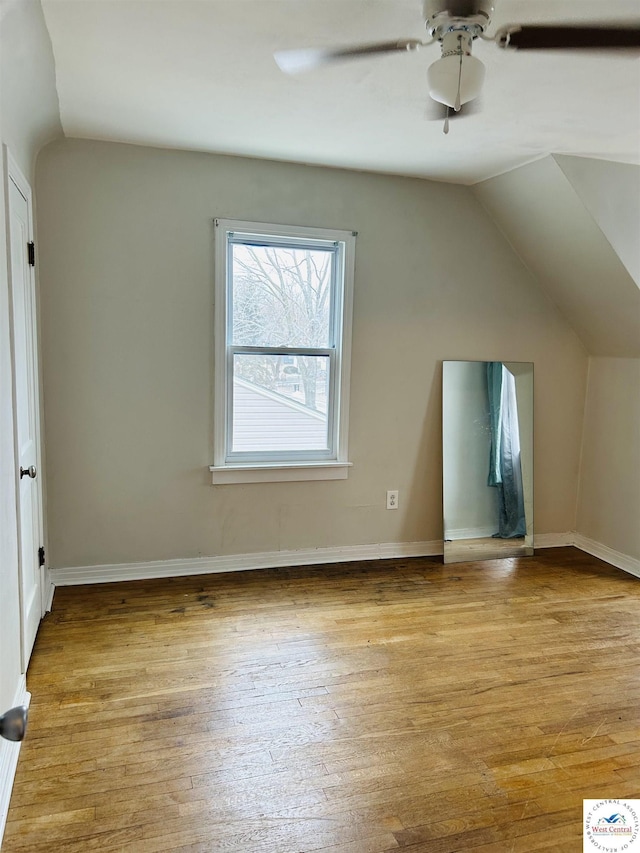 bonus room featuring a ceiling fan, baseboards, vaulted ceiling, and light wood finished floors