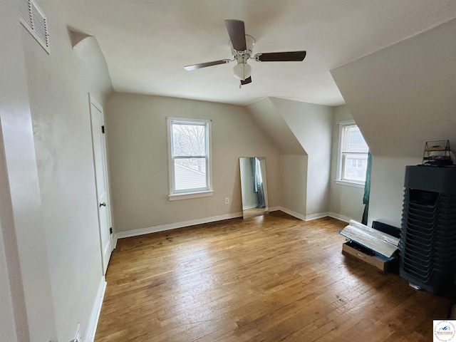 bonus room with baseboards, a ceiling fan, visible vents, and light wood-style floors