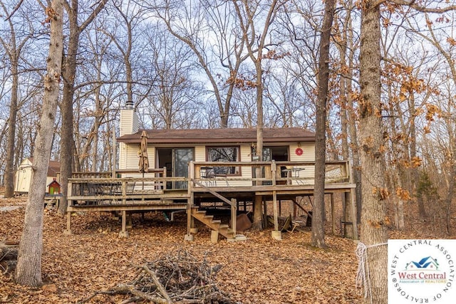 exterior space featuring a chimney and a wooden deck