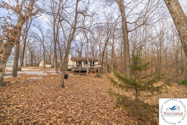 view of front of home featuring a chimney and a deck