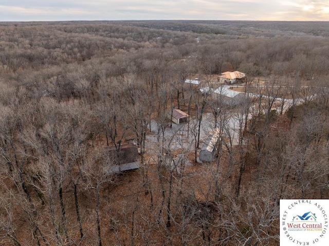 birds eye view of property with a view of trees