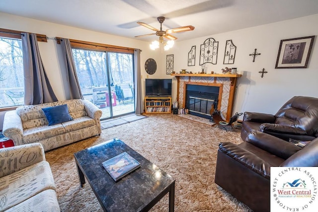 living room with carpet, a fireplace, and a ceiling fan