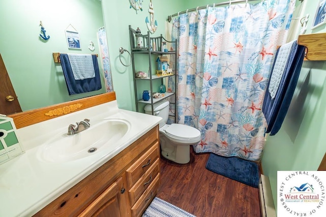 full bathroom with toilet, a baseboard heating unit, a shower with shower curtain, wood finished floors, and vanity