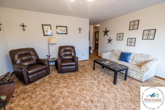 carpeted living area with baseboards