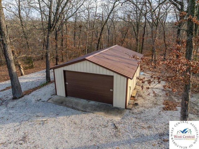 detached garage featuring a wooded view