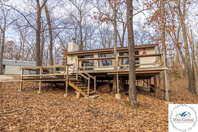 back of house with stairway, a chimney, and a wooden deck