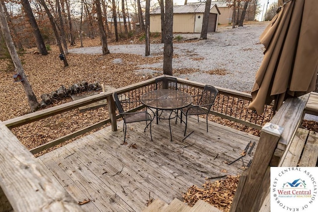 wooden terrace with outdoor dining space