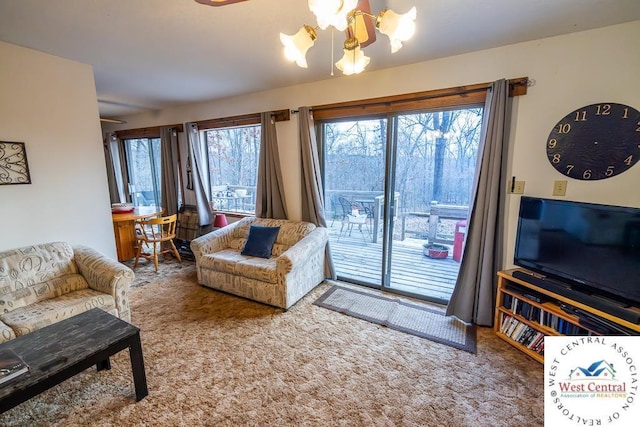 carpeted living area with a chandelier and a wealth of natural light