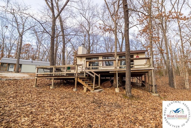 rear view of property with stairs, a chimney, and a wooden deck