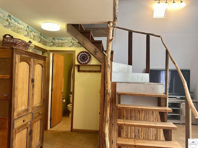stairway with tile patterned floors