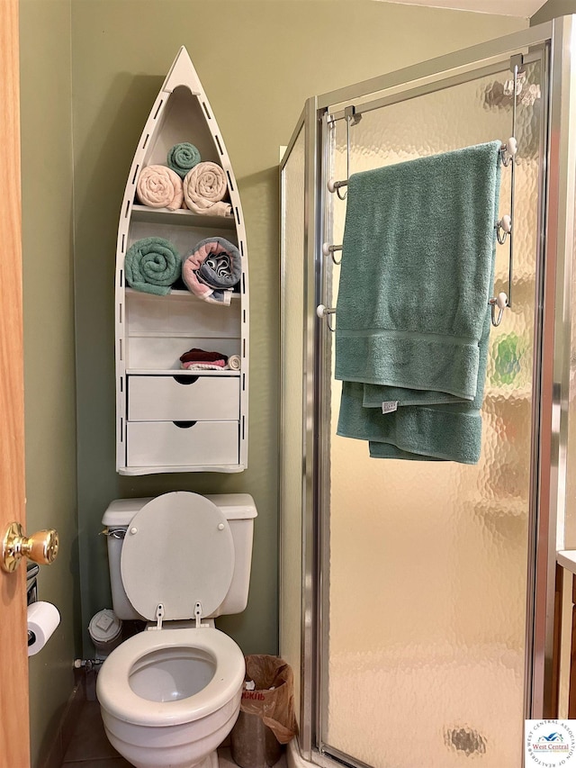 full bath with toilet and a stall shower