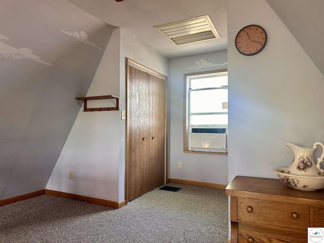 interior space with cooling unit, visible vents, vaulted ceiling, and baseboards