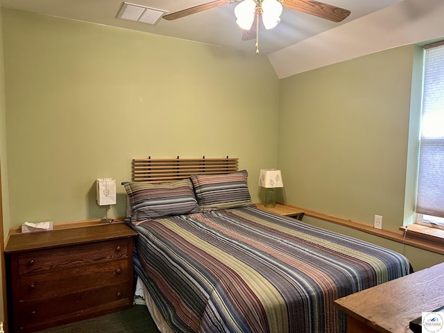 bedroom with visible vents, ceiling fan, and lofted ceiling