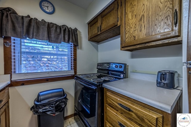 kitchen featuring black electric range and light countertops