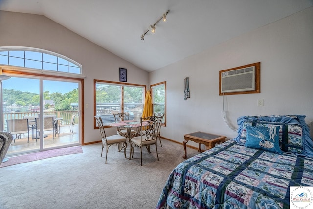 carpeted bedroom with baseboards, a wall mounted AC, lofted ceiling, rail lighting, and access to outside