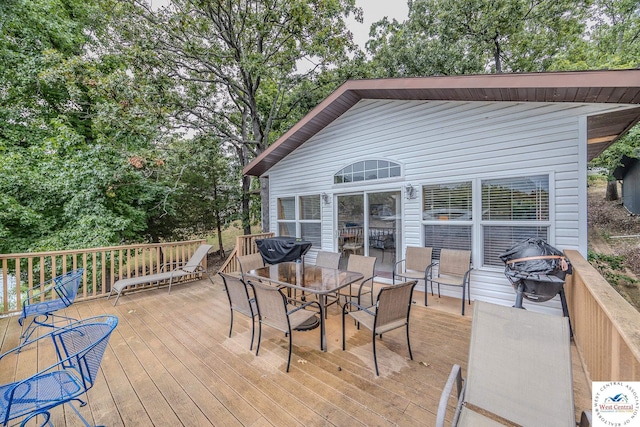 wooden deck featuring outdoor dining space