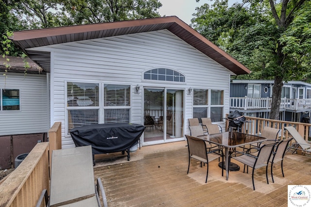 wooden deck featuring outdoor dining area