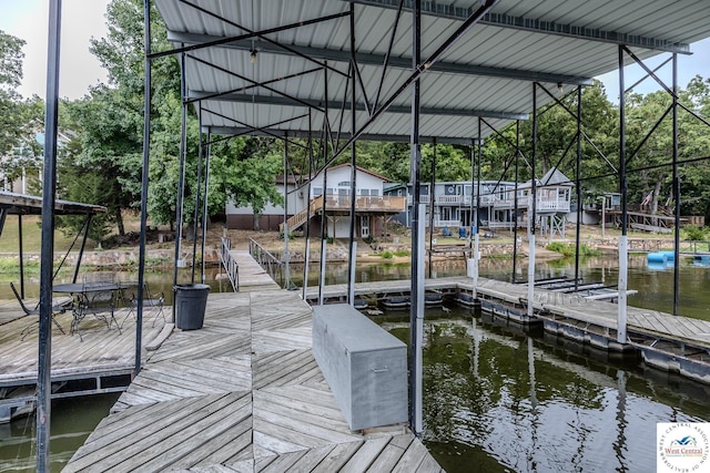 view of dock featuring stairs and a water view