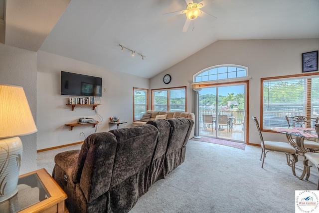 carpeted living room featuring a healthy amount of sunlight, baseboards, and vaulted ceiling