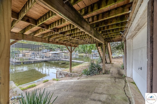 view of patio featuring a water view, a boat dock, and stairs