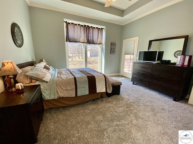 carpeted bedroom with baseboards, ornamental molding, a raised ceiling, and a ceiling fan