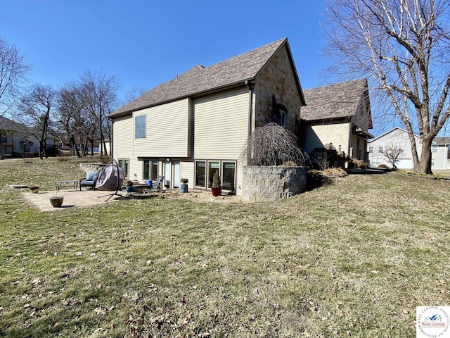 back of property featuring stone siding, a lawn, and a patio area