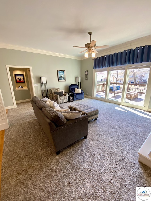 carpeted living area featuring ornamental molding, a ceiling fan, and baseboards