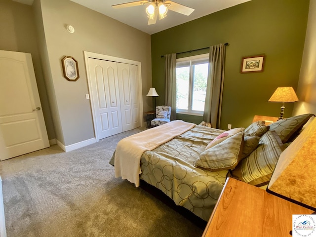 carpeted bedroom featuring lofted ceiling, a ceiling fan, baseboards, and a closet