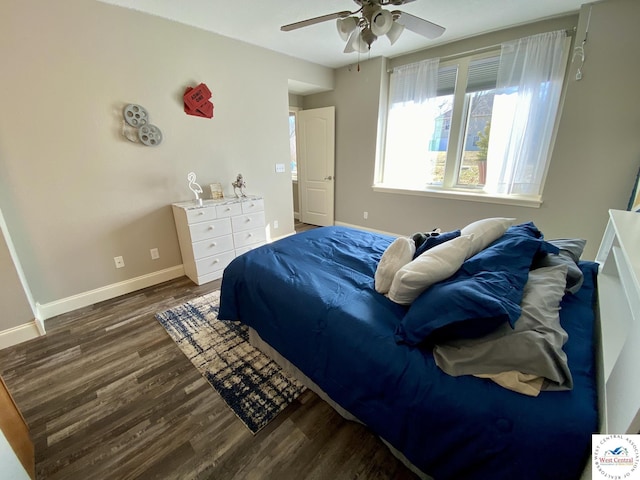 bedroom with a ceiling fan, baseboards, and wood finished floors