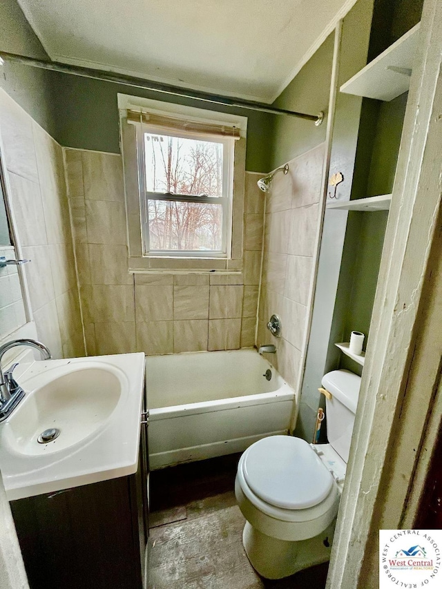 bathroom featuring toilet, shower / bath combination, and vanity