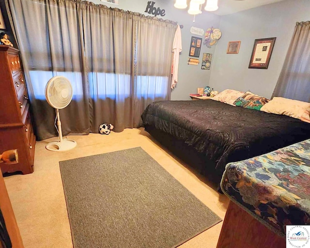 bedroom featuring light colored carpet