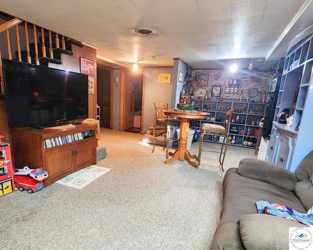 carpeted living room featuring stairway and visible vents