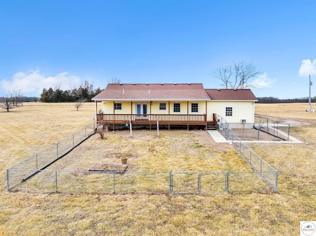 rear view of house featuring a gate, fence, and a wooden deck