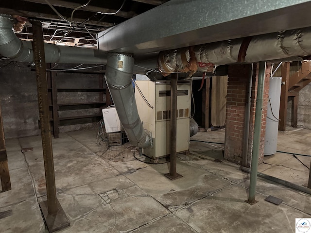 unfinished basement featuring gas water heater and heating unit