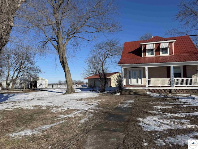 view of front of home with metal roof and a porch