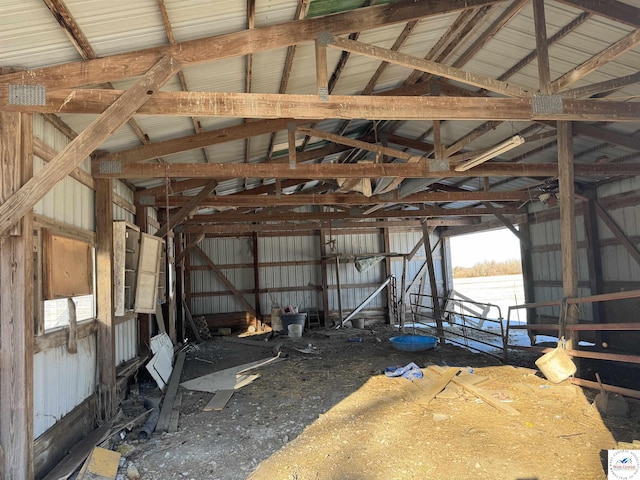 miscellaneous room featuring lofted ceiling and metal wall