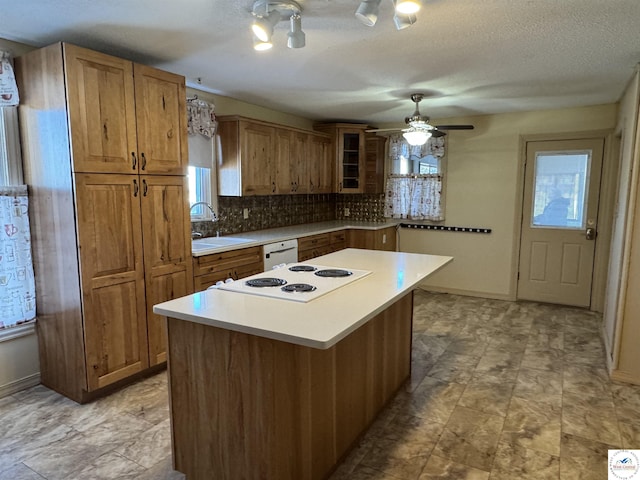 kitchen featuring light countertops, white appliances, glass insert cabinets, and a center island