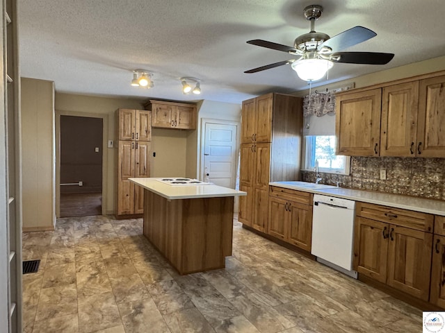 kitchen with light countertops, white appliances, a kitchen island, and brown cabinets