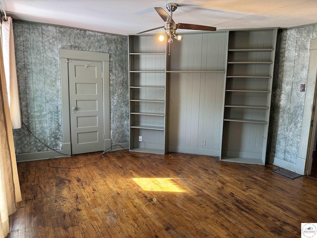 unfurnished bedroom featuring baseboards, visible vents, and dark wood finished floors