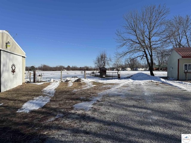 yard covered in snow with fence