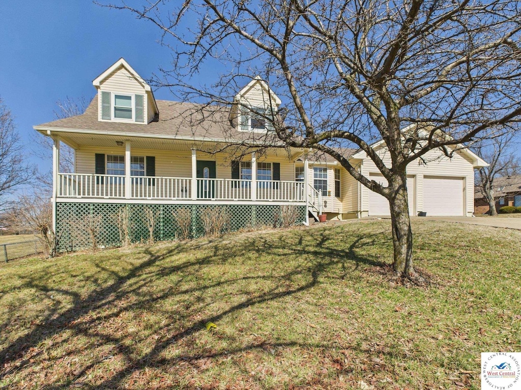 cape cod home featuring a front yard, a porch, an attached garage, a shingled roof, and concrete driveway