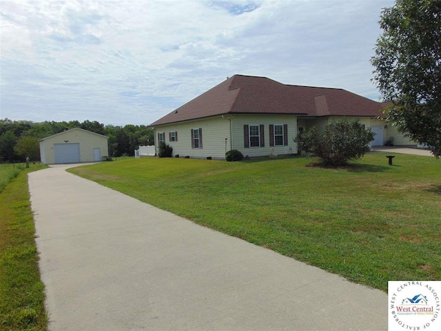 view of front of house with a front lawn, a garage, and an outdoor structure