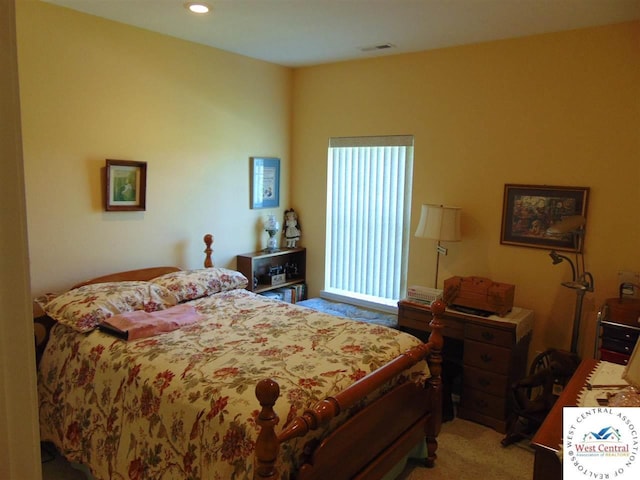 carpeted bedroom featuring visible vents