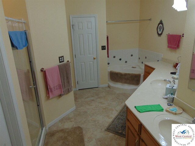 full bath with a shower with door, baseboards, a garden tub, double vanity, and a sink