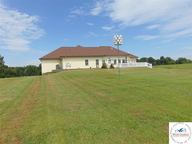 back of house featuring a yard