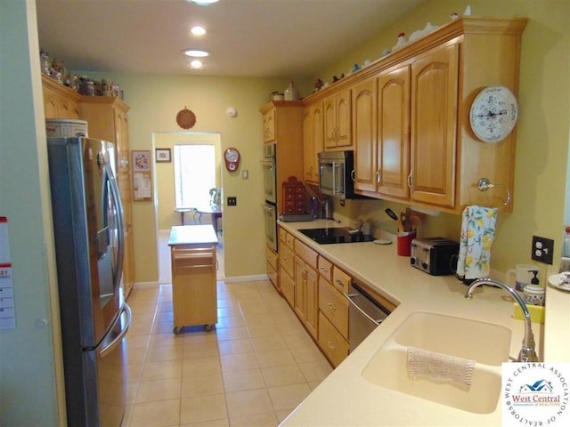 kitchen featuring a sink, recessed lighting, stainless steel appliances, light countertops, and light tile patterned floors