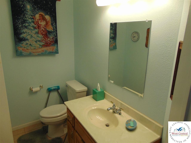 bathroom with tile patterned floors, toilet, and vanity