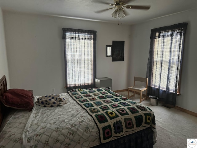 carpeted bedroom with baseboards and a ceiling fan